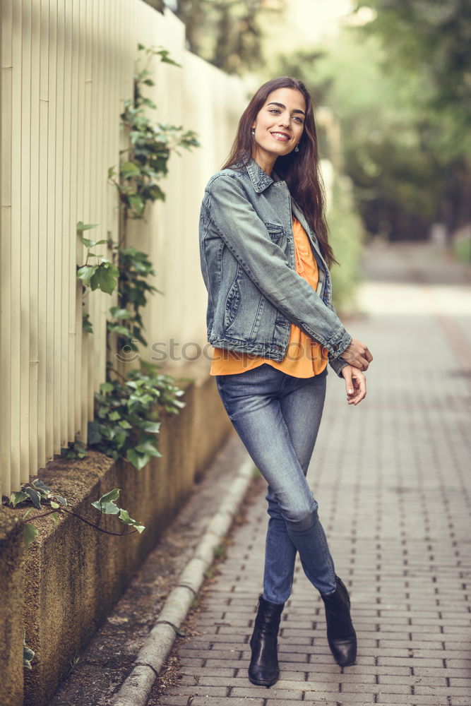 Similar – Young woman with moving hair wearing casual clothes