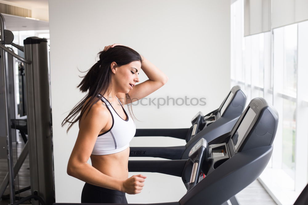 Similar – Woman resting after lifting barbell on muscular training