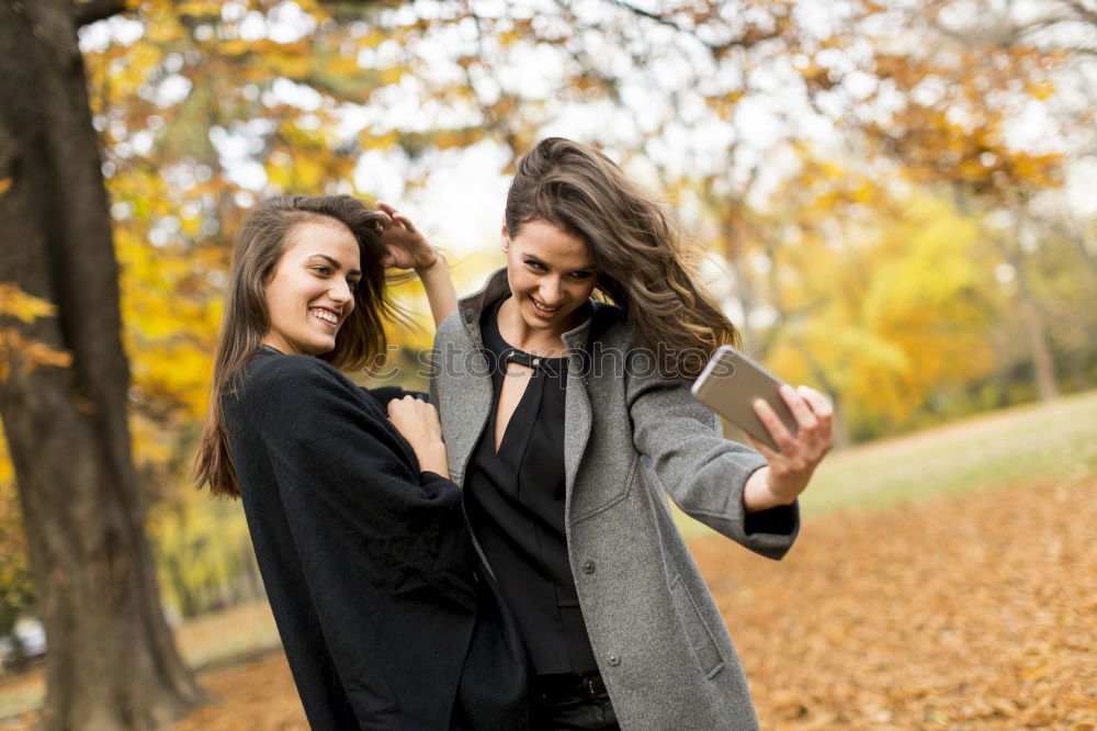 Similar – Two happy friends or sisters sitting and smiling