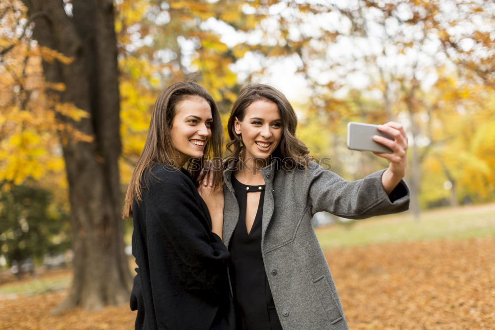 Similar – Beautiful women taking a selfie portrait in park.