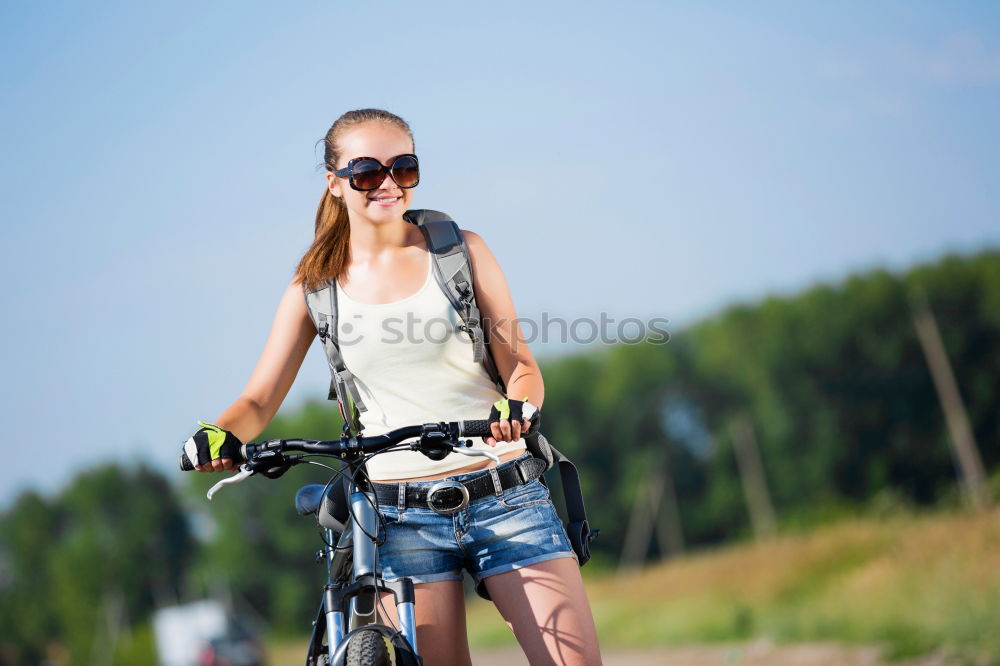 Similar – Image, Stock Photo Woman riding bike looking at camera